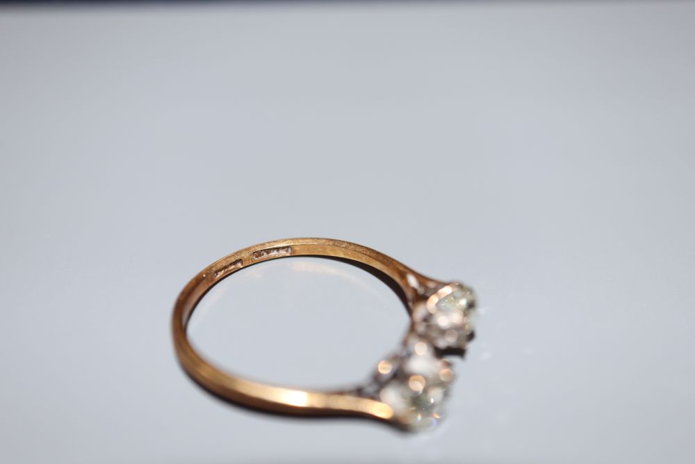 An 18ct and plat, two (ex three) stone diamond ring, size O/P, gross 2.4 grams.